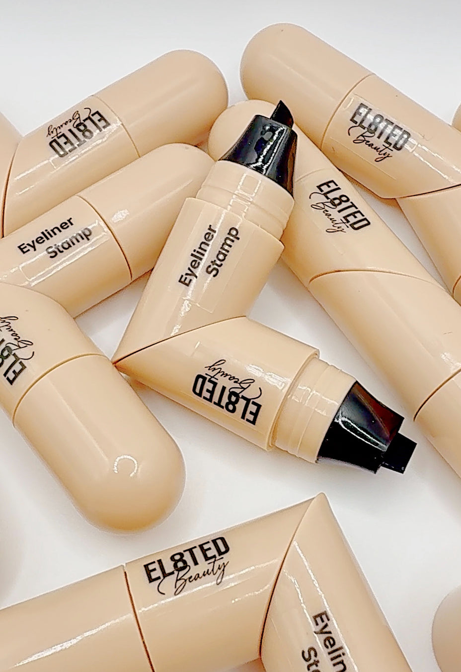 Eyeliner Stamp ✔️ by EL8TED BEAUTY displayed in a creative arrangement for flawless winged eyeliner.